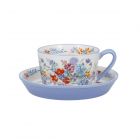 Ceramic teacup and saucer set with meadow print and purple blue contrasting handle and rim