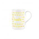 a white bone china mug with a yellow polka dot print, and text reading 'Auntie'