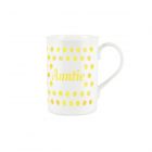 a white bone china mug with a yellow polka dot print, and text reading 'Auntie'