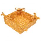 Square foldable bread basket made from ochre coloured recycled cotton, with a white polka dot print.