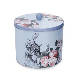 A blue round biscuit tin with a pink floral print and Alice in wonderland illustrations