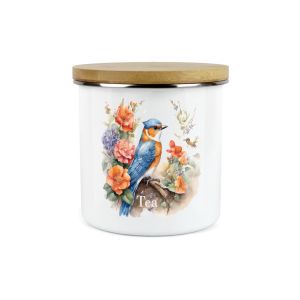 a white enamel tea canister with a blue and orange bird design and flowers