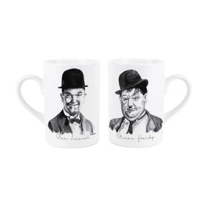 a pair of white ceramic mugs with black and white drawings of comedians laurel & hardy