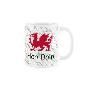 White ceramic mug with a red welsh dragon,splattered red and green background and hen nain (great grandma) text