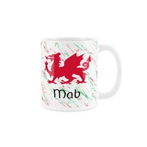 White ceramic mug with a red welsh dragon,splattered red and green background and mab (son) text