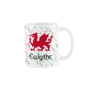 White ceramic mug with a red welsh dragon,splattered red and green background and ewythr (uncle) text